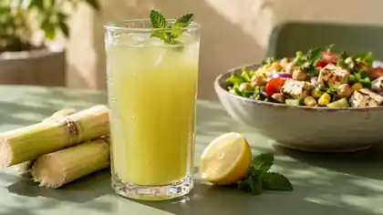 Sugarcane juice with lemon and mint beside a paneer, chickpea and corn bowl
